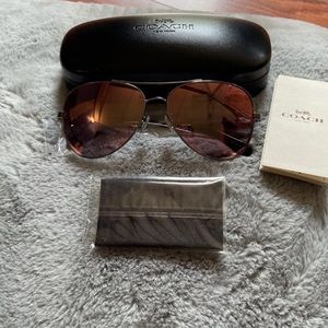 Coach Aviator Sunglasses with Pink Lenses.